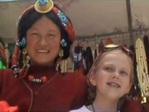 
Young son and daughter on Jokhang roof with Potala Palace behind - Tibet An Adventure With Our Children Youtube Video by Ed van der Kooy and Piet Warffemius
